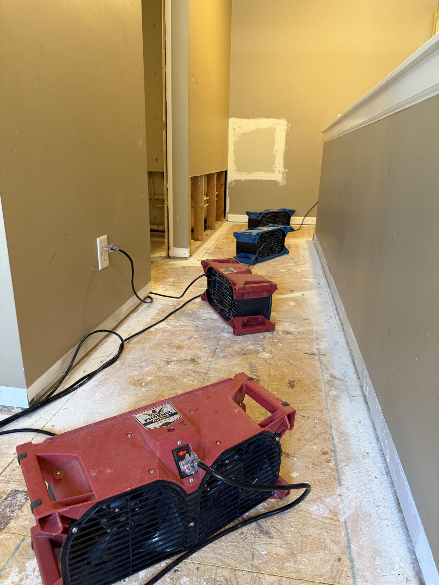 Banks of air movers staged across a commercial corridor