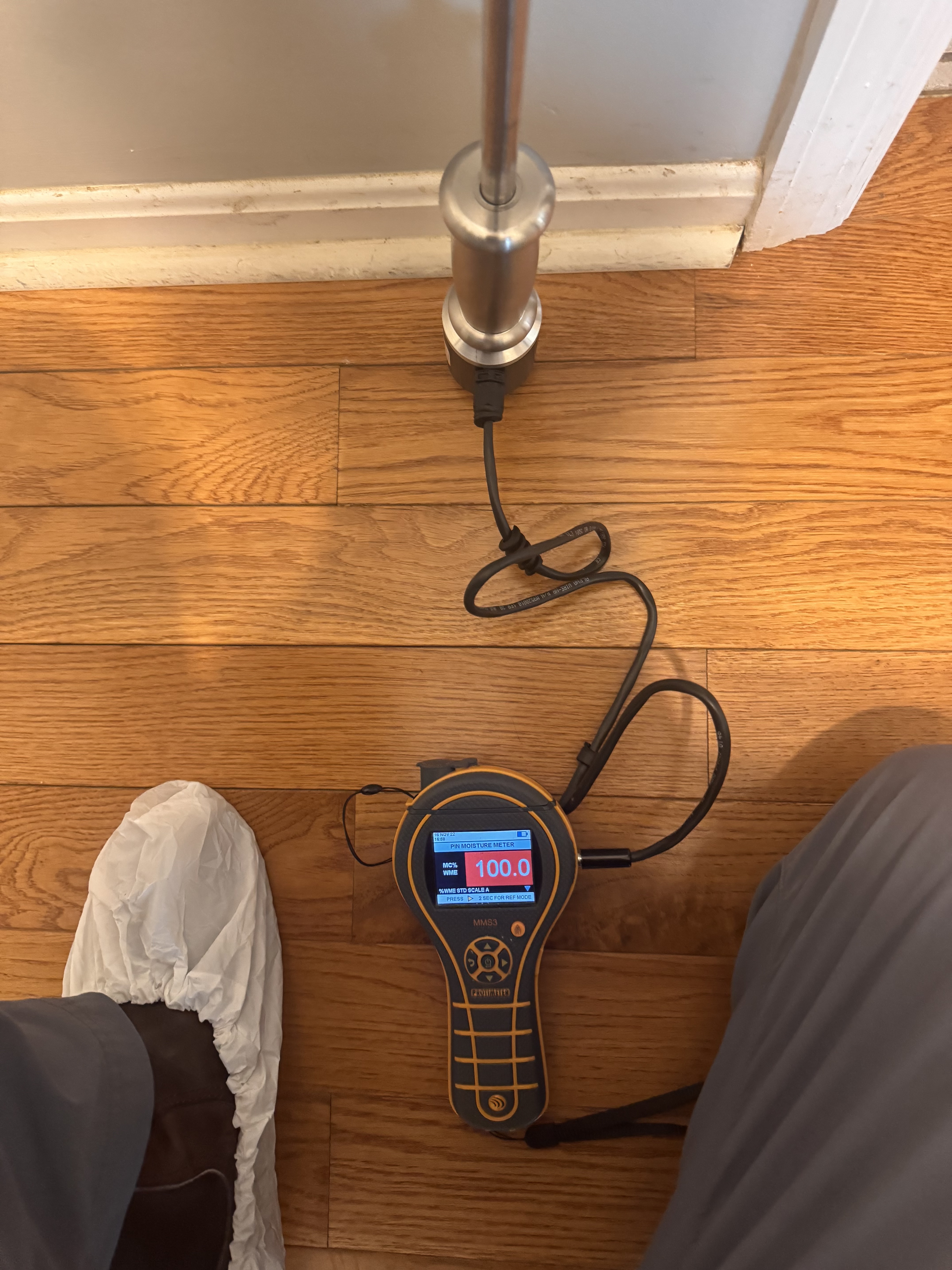 IRS technician using moisture meter to map water damage in a Steubenville home