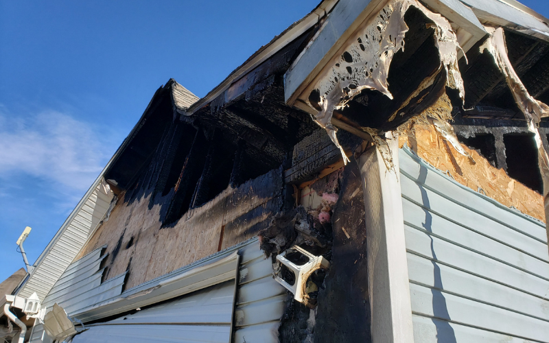 Exterior of a Steubenville house with fire damage to roof and siding